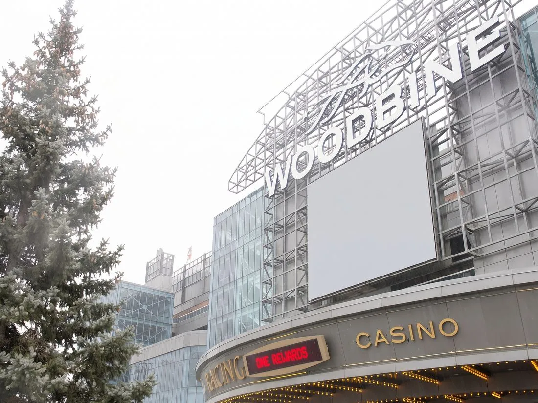 Woodbine sign and CASINO marquee beside a spruce